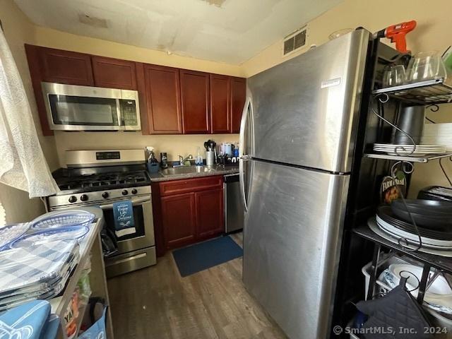 kitchen featuring sink, dark hardwood / wood-style flooring, and appliances with stainless steel finishes