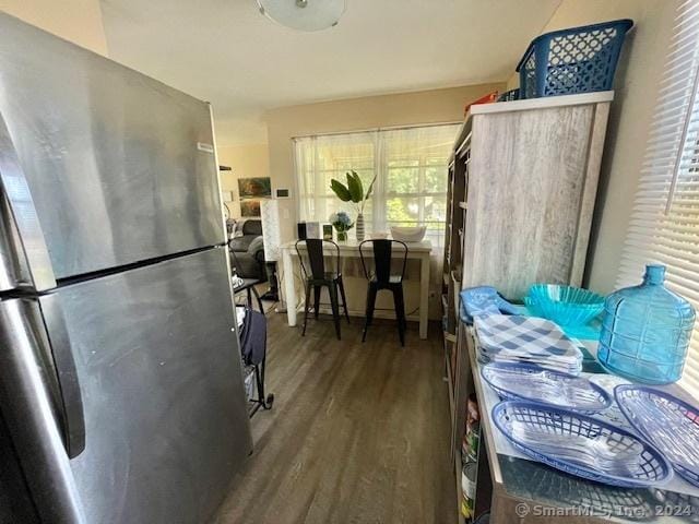 kitchen featuring stainless steel fridge and dark wood-type flooring