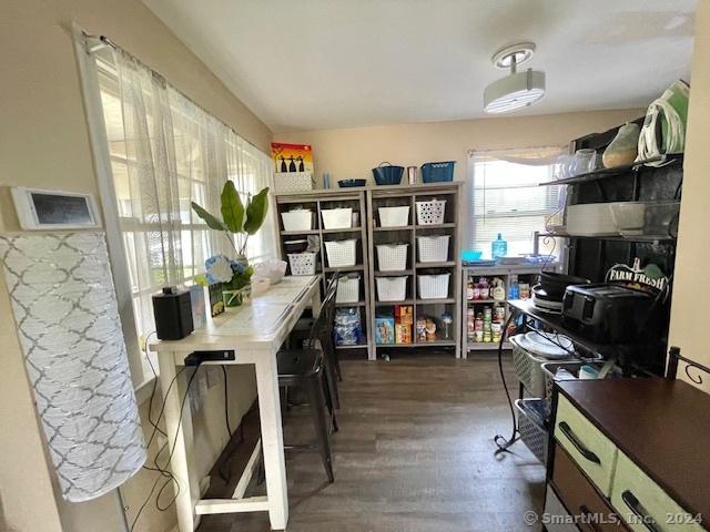 home office with dark hardwood / wood-style flooring