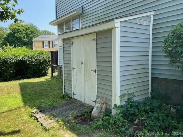 view of outbuilding with a lawn