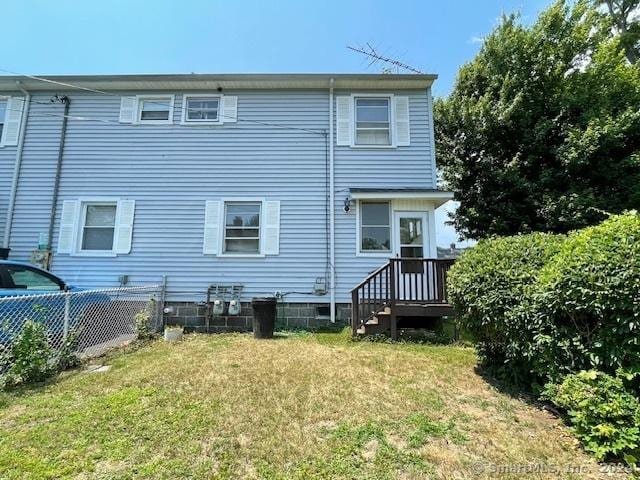 rear view of house featuring a yard