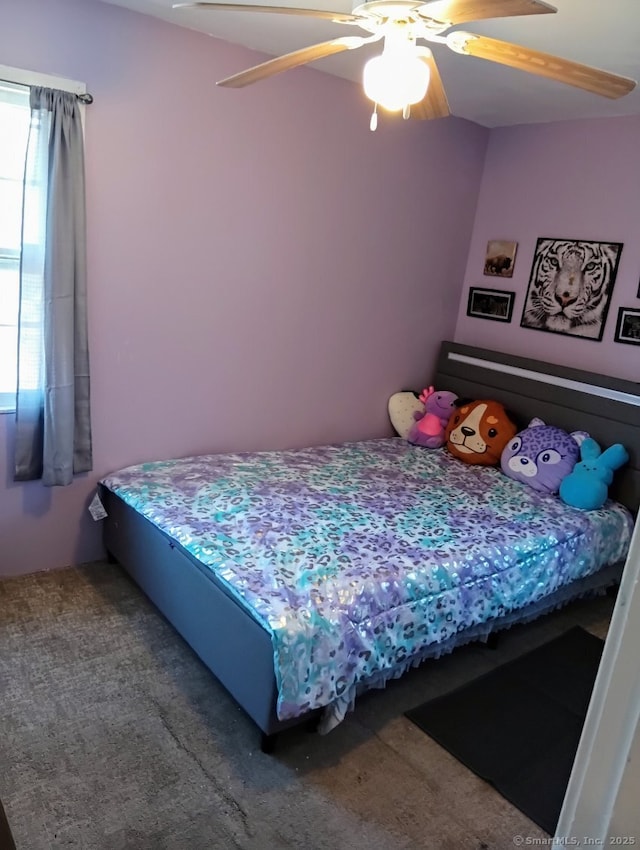 carpeted bedroom with multiple windows and ceiling fan