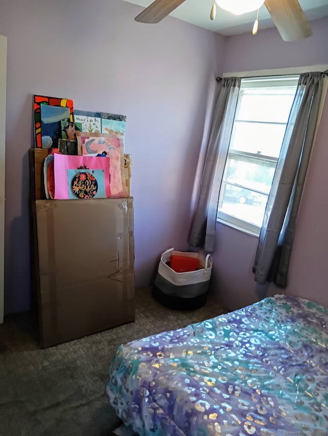 bedroom with ceiling fan and beamed ceiling