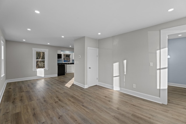 unfurnished living room featuring hardwood / wood-style flooring