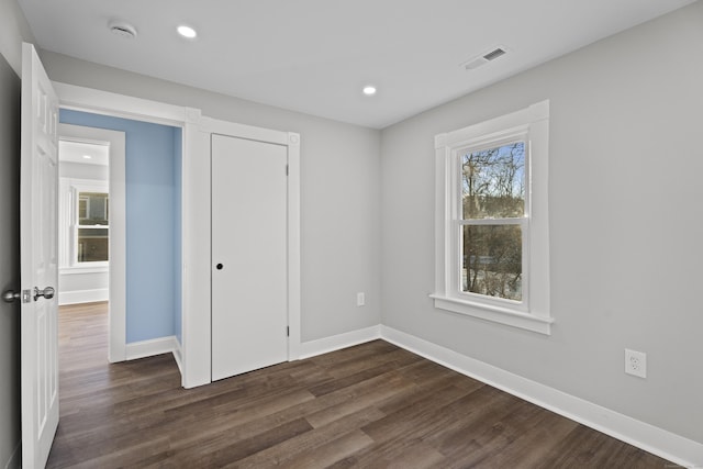 unfurnished bedroom with dark hardwood / wood-style floors