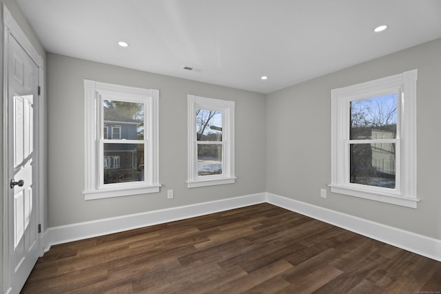 unfurnished room with dark hardwood / wood-style flooring