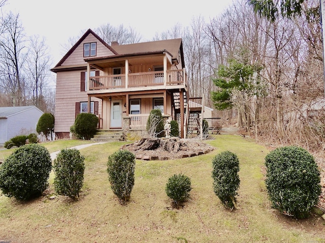 view of front of home featuring a front lawn and covered porch