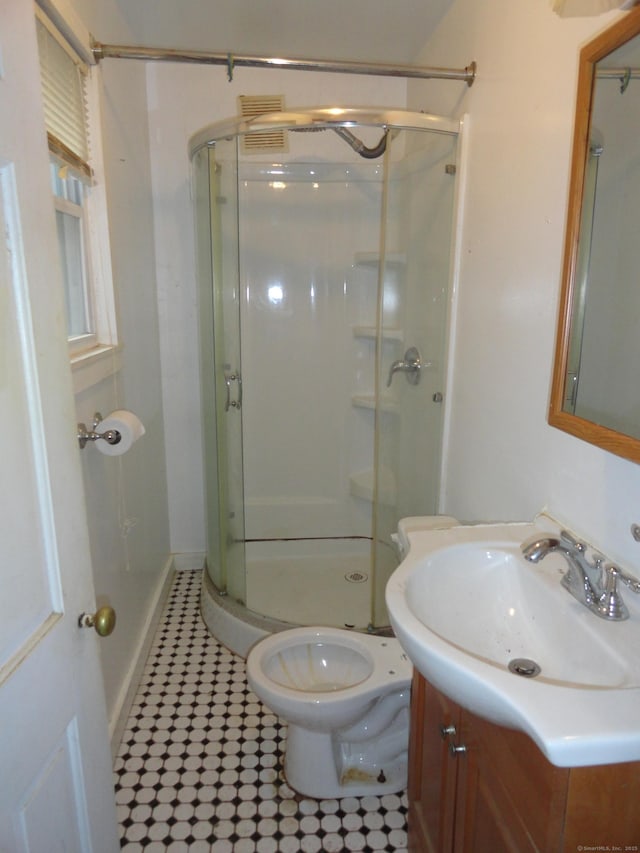 39 Baker St, Winchester, CT 06098 - bathroom featuring tile patterned floors, vanity, a shower with shower door, and toilet