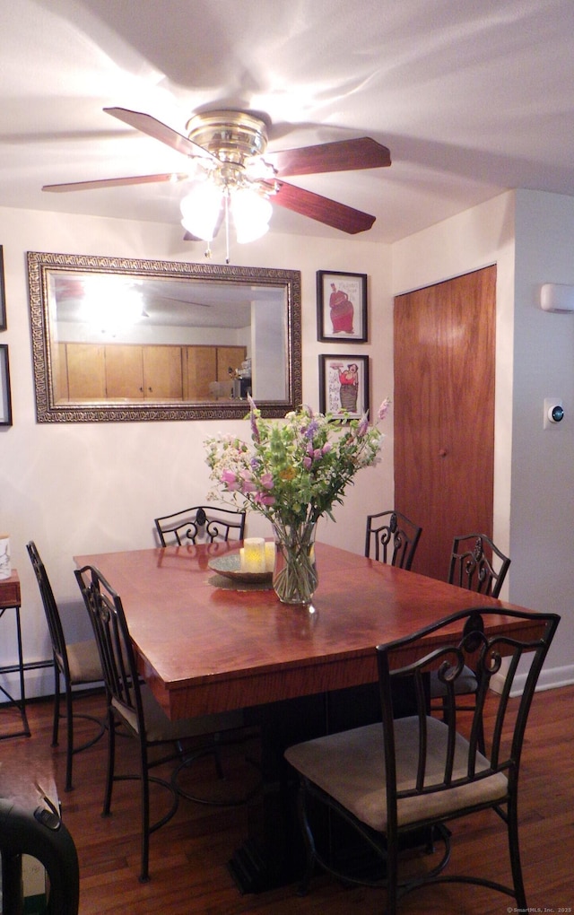 dining area featuring hardwood / wood-style floors and ceiling fan