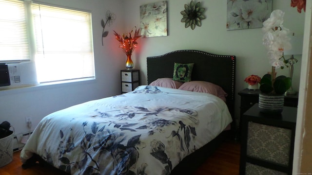 bedroom with wood-type flooring and multiple windows