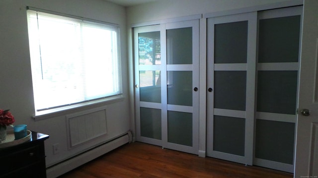 entryway with baseboard heating and dark wood-type flooring