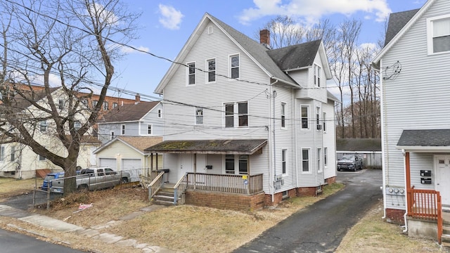 view of front of house featuring covered porch and a garage