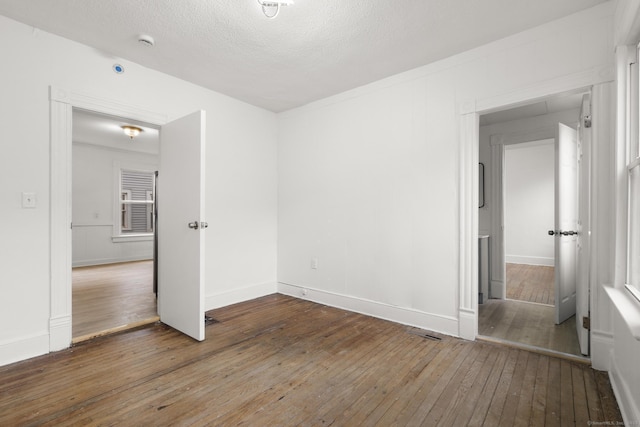 unfurnished bedroom featuring hardwood / wood-style floors and a textured ceiling