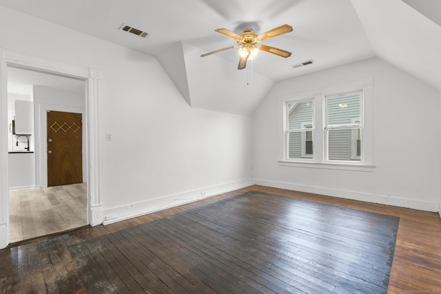 additional living space with ceiling fan, dark wood-type flooring, and lofted ceiling