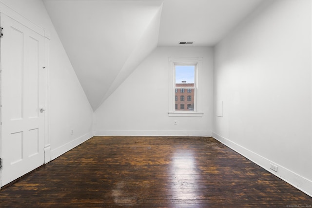 bonus room featuring dark hardwood / wood-style floors and lofted ceiling