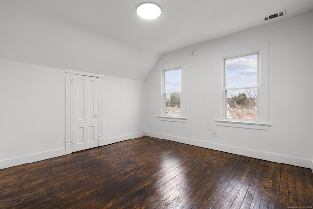 additional living space featuring dark hardwood / wood-style flooring and vaulted ceiling