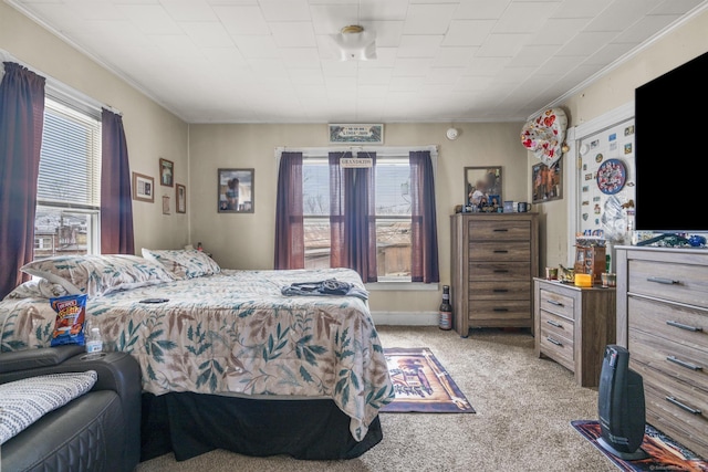 carpeted bedroom featuring ornamental molding