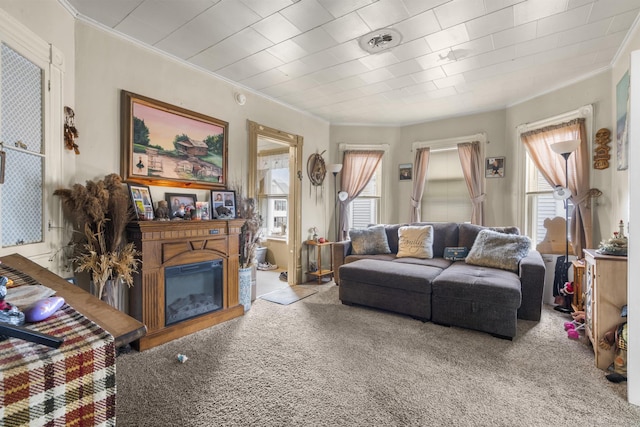 living room featuring ornamental molding, light carpet, and a wealth of natural light