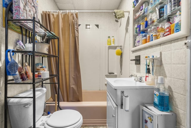 full bathroom with vanity, shower / bath combination with curtain, tile walls, and toilet