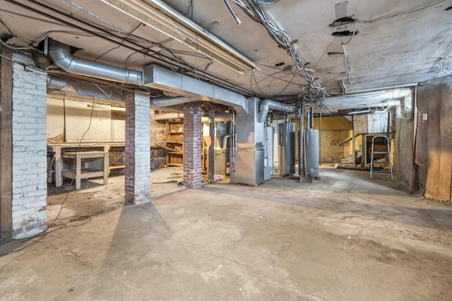 basement featuring heating unit and water heater