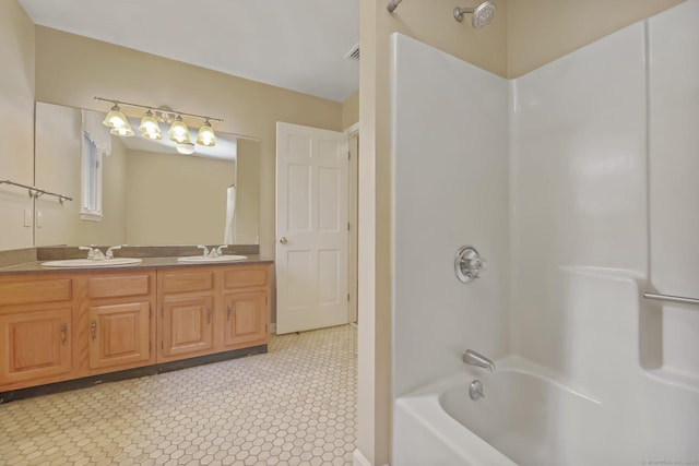 bathroom with tile patterned flooring, vanity, and shower / tub combination