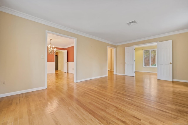 empty room with crown molding, light hardwood / wood-style flooring, and a chandelier