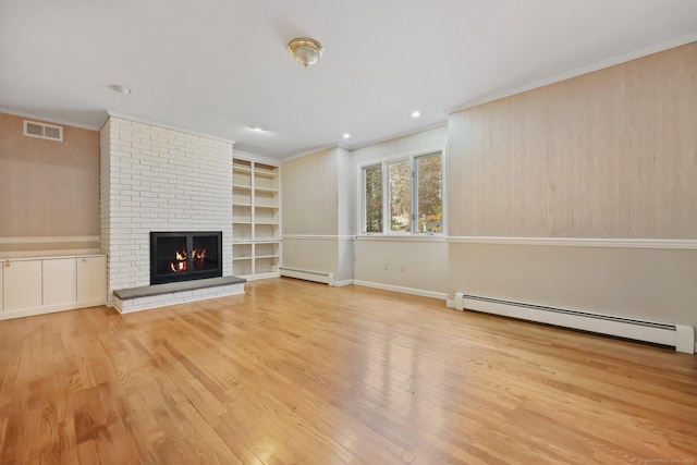 unfurnished living room with crown molding, a fireplace, light hardwood / wood-style floors, and baseboard heating