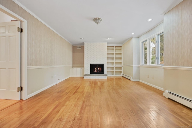 unfurnished living room featuring crown molding, a baseboard radiator, and built in shelves