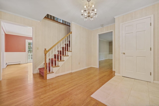 interior space featuring ornamental molding, a baseboard heating unit, a notable chandelier, and light hardwood / wood-style flooring