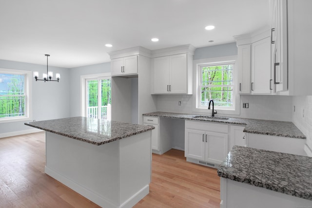 629 Hartford Rd, Salem, CT 06420 - kitchen with a sink, dark stone countertops, light wood-style flooring, tasteful backsplash, and recessed lighting