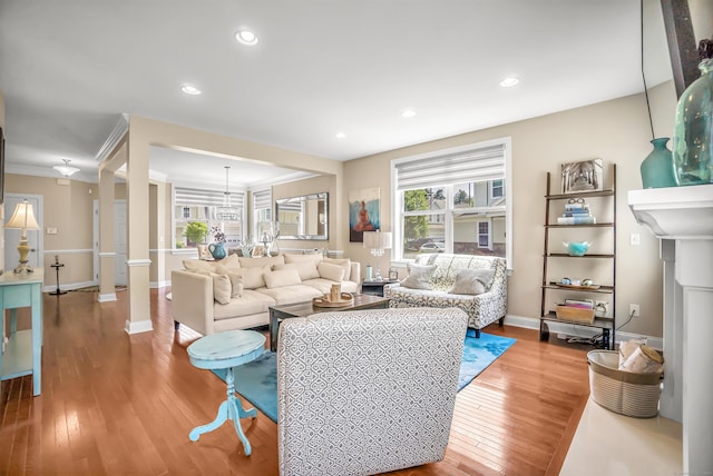 living room with wood-type flooring and ornamental molding