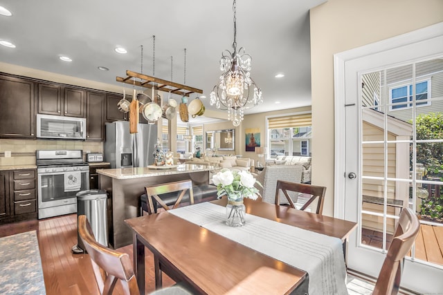 dining area featuring a chandelier and dark wood-type flooring