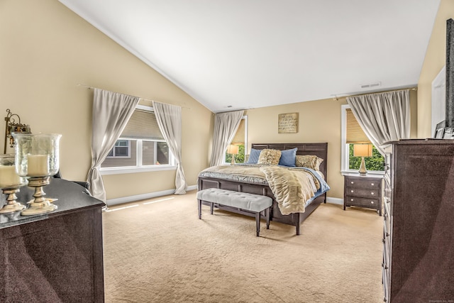 bedroom featuring light colored carpet and vaulted ceiling