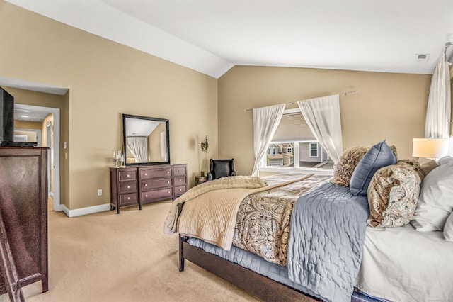 carpeted bedroom with lofted ceiling