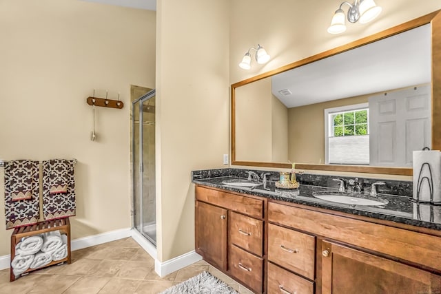 bathroom with tile patterned flooring, vanity, and a shower with door