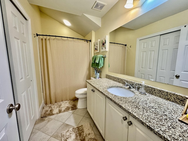 bathroom with vanity, vaulted ceiling, tile patterned flooring, toilet, and walk in shower