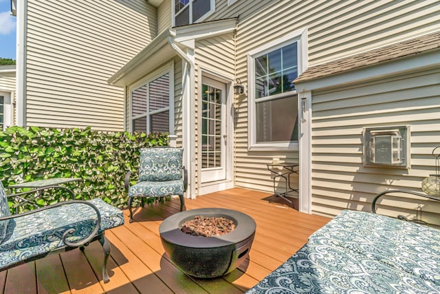 wooden deck featuring a fire pit