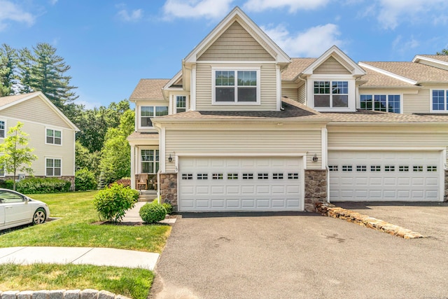 view of front of home featuring a garage and a front lawn