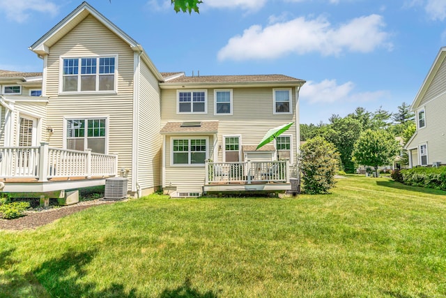 rear view of property with cooling unit, a deck, and a yard