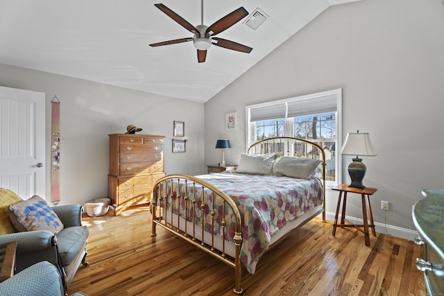 bedroom with ceiling fan, wood-type flooring, and vaulted ceiling