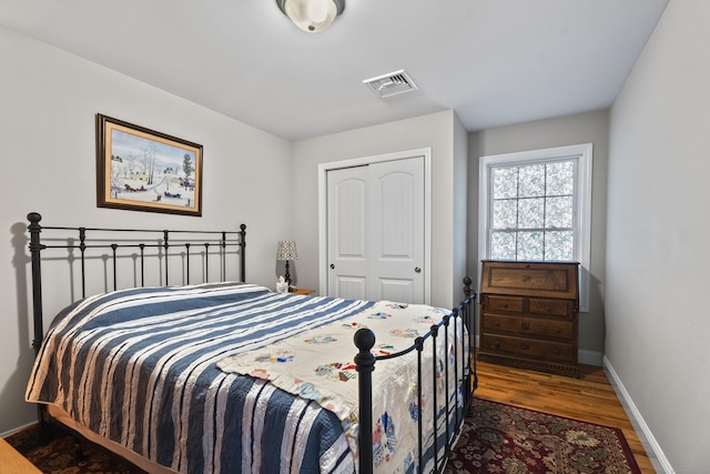 bedroom featuring a closet and dark hardwood / wood-style floors