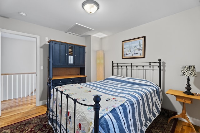 bedroom with hardwood / wood-style floors