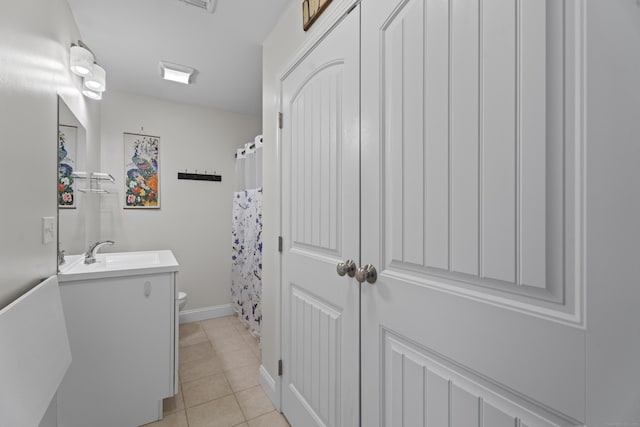 bathroom featuring tile patterned floors, a shower with curtain, vanity, and toilet