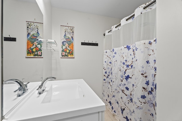 bathroom featuring tile patterned flooring, a shower with curtain, and vanity