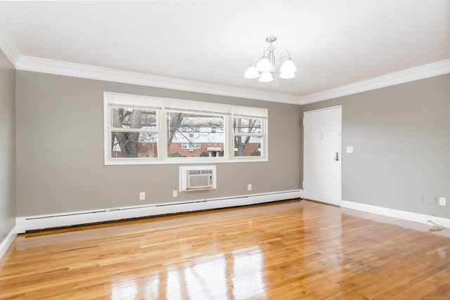 spare room featuring an AC wall unit, a baseboard radiator, ornamental molding, and a notable chandelier