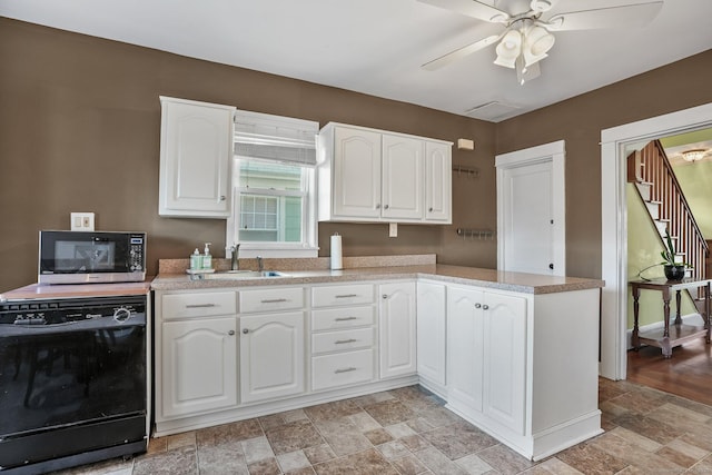 kitchen with white cabinets, dishwasher, and sink