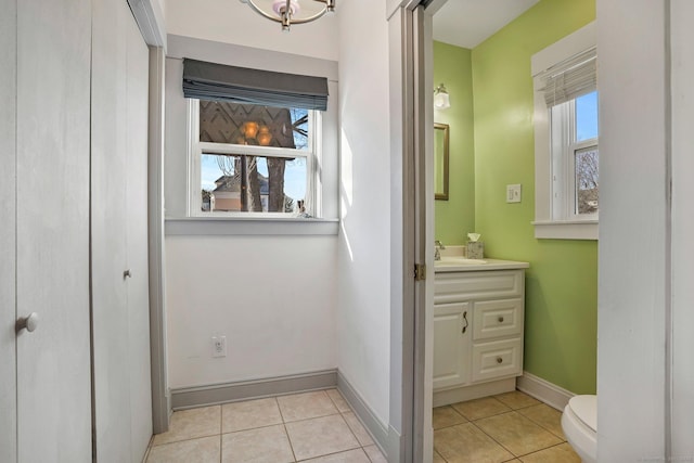 bathroom featuring toilet, vanity, and tile patterned floors