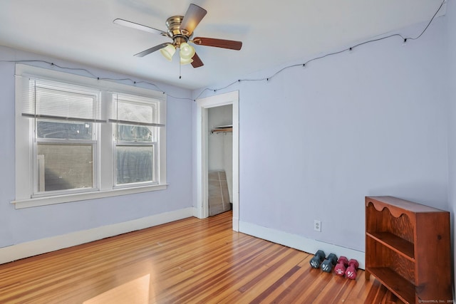 unfurnished bedroom featuring a closet, light hardwood / wood-style flooring, and ceiling fan