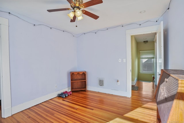 spare room with ceiling fan and light hardwood / wood-style flooring