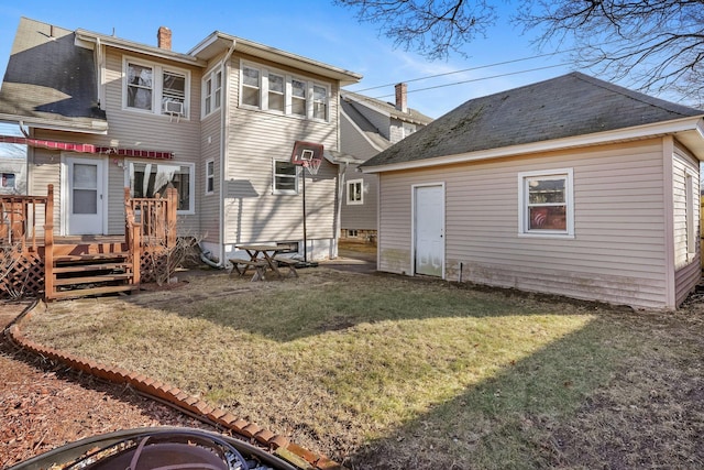 back of house featuring a lawn, cooling unit, and a wooden deck